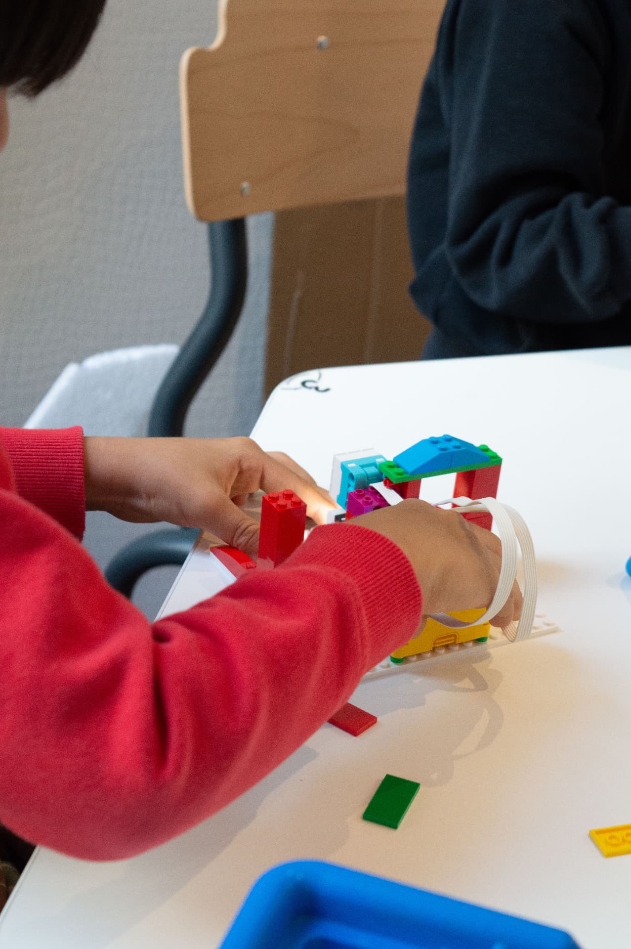 Children building a model together during a holiday session